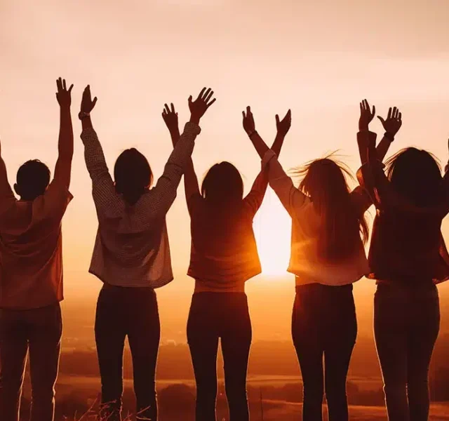 group-friends-standing-hilltop-rejoicing-raising-their-hands-air-with-beautiful-sunset-background.jpg